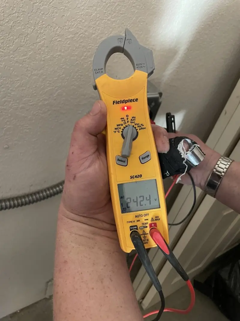 Voltage testing with clamp meter during Outlet Installation in Frostproof